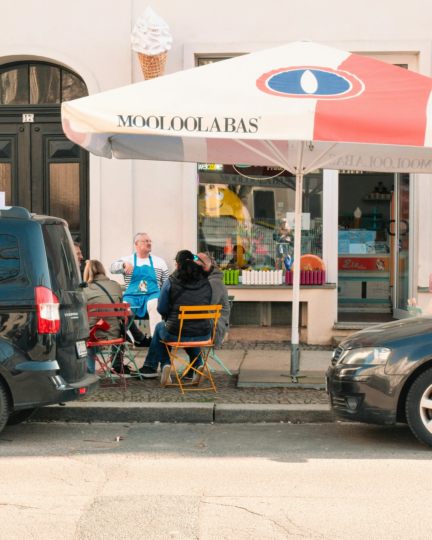 People sharing a treat outside an ice cream shop