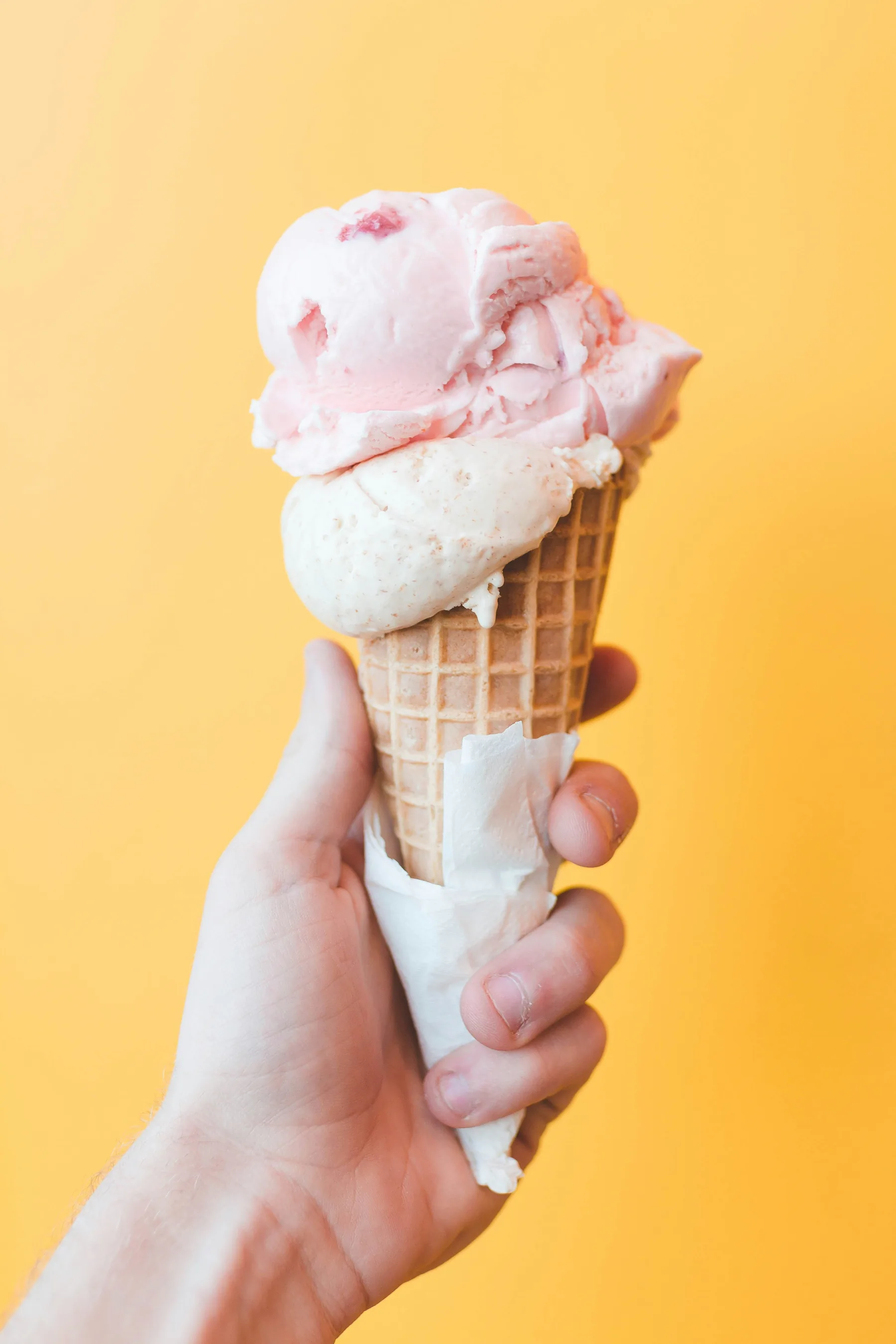Strawberry ice cream in a waffle cone